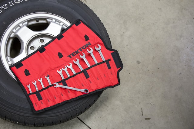 car wheel with a pack of wrenches laying on top
